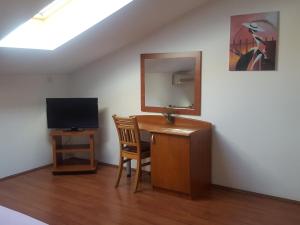 Televízia a/alebo spoločenská miestnosť v ubytovaní Apartments Villa Novak