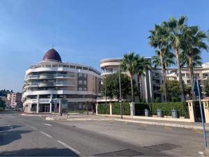 a building with palm trees in front of a street at New appartement with 2 bedrooms in a new building in Cagnes-sur-Mer