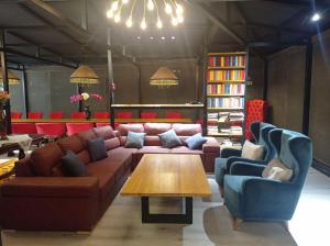 a living room with a couch and chairs and a table at Comfortable Home Stay in Termiz