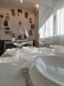 two empty wine glasses sitting on a white table at Apartment 15 in Borovets