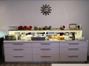 a kitchen with a white counter with dishes on it at Grand Bells Bed And Breakfast in Zagreb