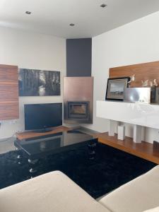 a living room with a couch and a fireplace at Chalet Villa turística con vistas al mar Breakfast items in the home in Faro de Cullera