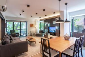 a dining room and living room with a wooden table at Deger 16 Residences in Istanbul