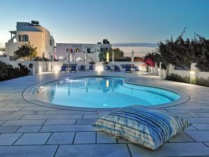 a swimming pool in the middle of a patio at Ikaros Studios & Apartments in Naxos Chora
