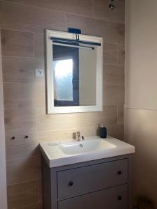 a bathroom with a white sink and a mirror at EL PAJAR DE LEONOR in Horcajuelo de la Sierra