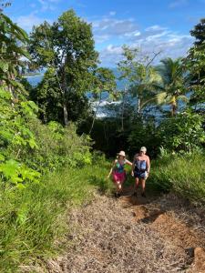 a man and a child walking down a trail at Alojamiento in Bahía Solano +31 photos