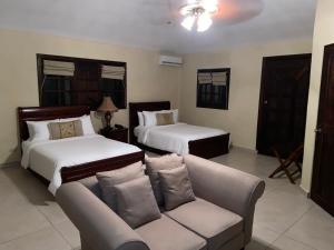 a living room with two beds and a couch at Valle Escondido Resort Golf & Spa in Boquete