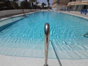 a swimming pool with a metal object in the water at playa honda luxury in Arona