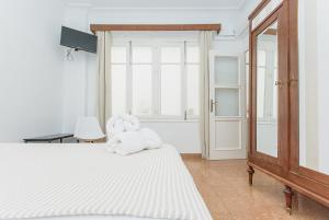 a bedroom with a bed with a stuffed animal on it at Apartamento San Pascual en Orihuela in Orihuela