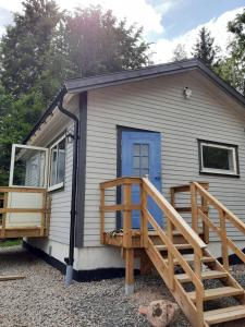 a tiny house with a porch and a deck at Villa Gebbie in Vessigebro