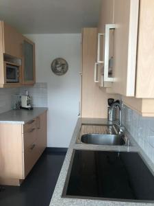 a kitchen with a sink and a counter top at Swiss Mountains in Leysin