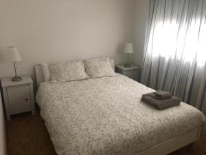 a bedroom with a bed and two lamps and a window at Swiss Mountains in Leysin