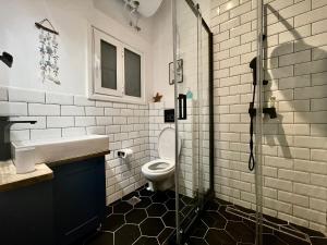 a bathroom with a toilet and a sink and a shower at B & B House Apartment in Athens