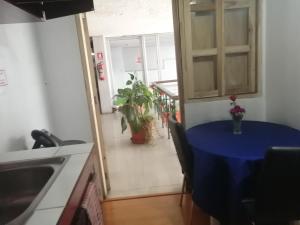 a kitchen with a table with a blue table cloth on it at Escocie Quito Colonial in Quito