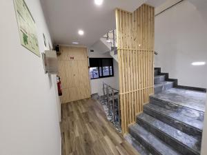a hallway with a staircase with wood paneling at Casa Borges in Charneca