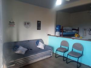 a living room with a couch and two chairs at Nosso Pedacinho in Abraão