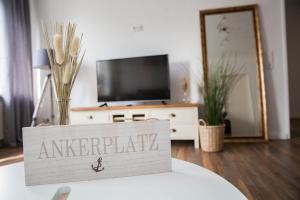 a sign that says antwerp in front of a tv at Ferienwohnung Nordlicht zentral in der Innenstadt in Eutin