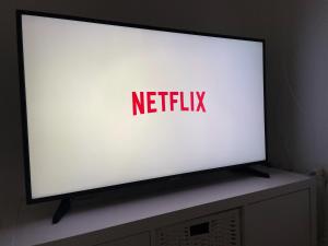 a television screen with the netflix logo on it at Sweet apartment in Calafell