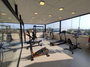 a gym with treadmills and ellipticals in a building at Hotel Nossa Casa in Ijuí