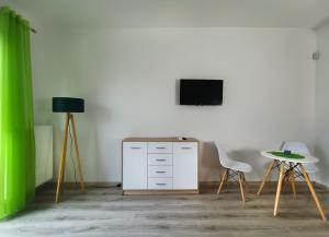 a room with a desk and a tv and a chair at Pensjonat Na Każdą Porę in Lądek-Zdrój