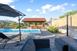 a swimming pool with a gazebo and an umbrella at Olive Tree House with Jacuzzi, WiFi and 40m2 pool in Širitovci