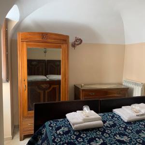 a bedroom with a bed with towels on it at La Dimora di Ziella in Barisciano