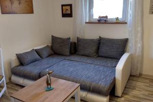a living room with a couch and a table at Ruhige Ferienwohnung inkl. Garten im Unterallgäu in Lachen
