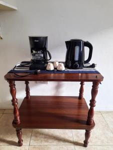 a table with a coffee maker and a coffee pot on it at DEPARTAMENTO COSTANERA in Corrientes
