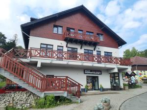 a large building with a red and white building at Apartament 515 in Szklarska Poręba