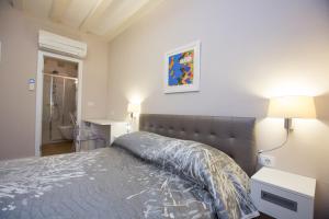 a bedroom with a bed and a bathroom at Villa Flores Room in Dubrovnik