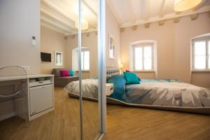a bedroom with a bed and a sink in a room at Villa Flores Room in Dubrovnik