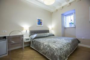 a small bedroom with a bed and a window at Villa Flores Room in Dubrovnik