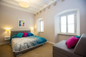 a bedroom with a bed and a couch at Villa Flores Room in Dubrovnik