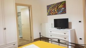 a bedroom with a bed and a tv on a dresser at B&B Casa Vacanza Centro Sardegna in Sorgono