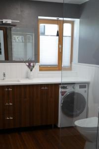 a bathroom with a sink and a washing machine at Tolli korter in Kuressaare