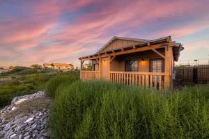 a small cabin on a rocky hill with a sunset at -Pet Friendly- Miners Cabin #5 -Two Double Beds - Private Balcony in Tombstone