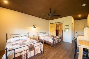 a hotel room with two beds and two lamps at Tombstone Miners Cabins in Tombstone