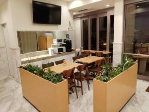東京にある赤坂アーバンホテルのテーブルと椅子のあるレストラン、キッチンが備わります。