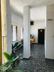 an empty hallway with a desk in a building at Hotel Costa Norte in Santa Marta