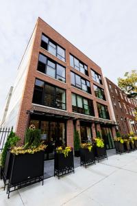 a building with tables and chairs in front of it at The Maj Hotel in Philadelphia