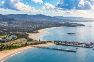 an aerial view of a beach with a pier at Surf Beach Motel Coffs in Coffs Harbour