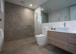 a bathroom with a toilet and a sink and a shower at Links Lodge at The Dunes in Rye