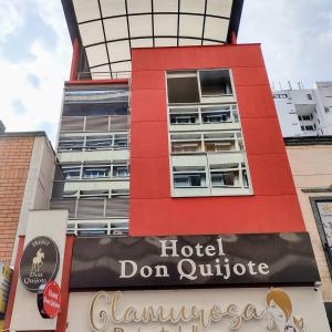 a red building with a hotel dont outride sign in front at HOTEL DON QUIJOTE in Pereira