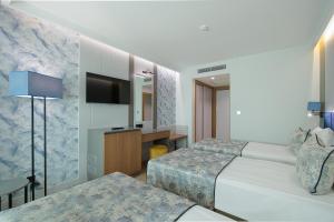 Rúm í herbergi á Sealife Kemer Resort Hotel - Ultra All Inclusive