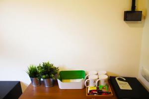 a wooden table with cups and plants on it at 悦心旅Yesing Hotel in Taipei