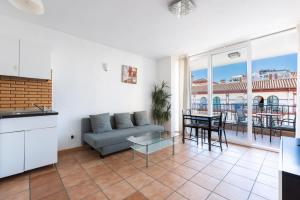 a living room with a couch and a table at Apartment Fuengirola City Station in Fuengirola