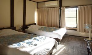 Voodi või voodid majutusasutuse Sakura Guest House toas