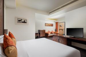 a hotel room with a bed and a television at Mangrove Tree Resort World Sanya Bay-Kapok in Sanya