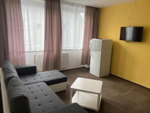 a living room with a couch and a tv at Penzion Teplanka in Považská Bystrica