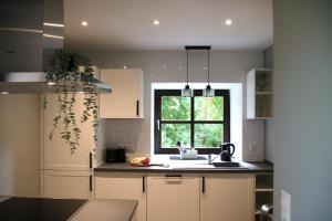 a kitchen with a sink and a window at Ferienhaus EifelNest in Scheid